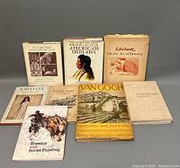 Overview photo shows eight art and Native American history books arranged on a gray surface, covers visible.