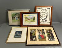 Group view of five framed artworks: two watercolors, caricature, triptych print, winter print