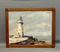Full view of the lighthouse oil painting with wooden frame on grey background.