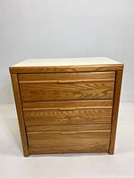 Front view of Stanley Furniture 3 drawer wooden cabinet showing natural wood grain finish and drawer layout