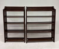 Pair of vintage solid oak bookshelves seen from front on white background.