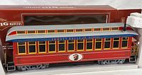 Side view of red and yellow Bachman Big Hauler G scale observation train car in original packaging, featuring Emmett Kelly Jr. Circus graphics and detailed windows.