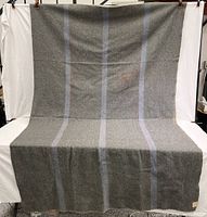 Full view of vintage Australian military wool blanket gray with blue and red stripes.
