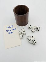 Overview of brown leather dice cup and ten white dice