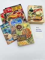 Front view showing all five cookbooks and magazine in stack