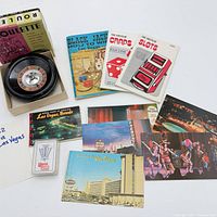 Top view showing roulette wheel, booklets, postcards and playing-card deck