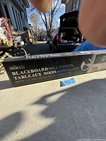 Photo of the boxed blackboard wall stickers showing packaging and branding.