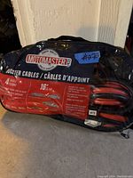Clear photo of Motomaster booster cables in original bag, label showing brand, length, gauge, and features, as well as pair of red and black cables visible.