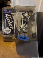 Front angle photo of the Daryl Sittler NHL hockey figurine in its original packaging, showing the figure and box branding.
