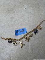 Photo showing vintage NHL Toronto Maple Leafs charm bracelet laid flat with all charms visible.
