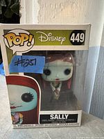 Funko Pop! Disney Sally figure in box, front view showing figure and packaging details including number 449 and character name.