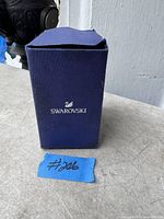 Original blue Swarovski box with logo displayed.