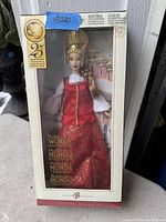 Barbie Dolls of the World doll in original sealed box, dressed in red and gold traditional attire with intricate gold headdress.