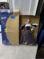Vintage Barbie doll in original box with dress and accessories visible
