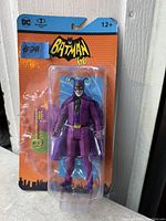 Photo shows Batman '66 action figure in purple jester costume in original packaging, unopened.