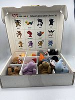 View of the open box showing the McDonald's Special Edition Collector's Set of Beanie Babies neatly organized in compartments with character names and images on the box top insert.