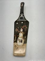 Front view of the spatula showing snowman holiday design and overall shape.