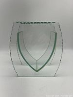 Front view of the clear glass vase showing the double-wall construction and V-shaped inset design with rounded square outer shape.