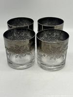 Photo of four vintage glasses with platinum silver fade and floral etching, front angled view