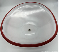 Top view of the clear glass bowl with red rim, showing smooth curved design and diameter.
