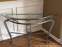 Half-moon glass topped corner table angled in room corner, showing overall design and condition.