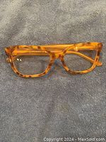 Front view of tan tortoiseshell Tory Burch eyeglasses showing rectangular frame shape and clear lenses.