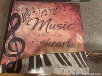 Music-themed wooden sign with treble clef, notes and quote
