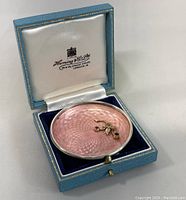 Dish displayed inside original blue leatherette hinged case with white satin lid marked 'Henning & Co Ltd 28 & 29 Conduit Street, London W' and navy velvet base