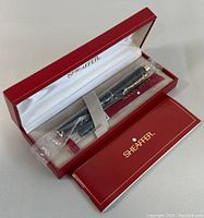 Sheaffer pen in original red box with white satin interior, pen sealed in plastic with paperwork included.