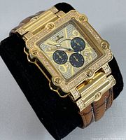 Close-up three-quarter view of watch face angled on cushion