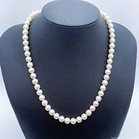 Front view of pearl necklace displayed on bust