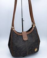 Front angle view of bag showing paisley print body and leather trim