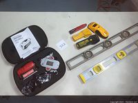 Full lot overview showing the Craftsman 4-in-1 Level with Laser Trac in its carrying case with manual, two metal levels, and four various stud sensors.