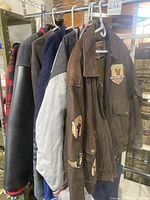 Five Mickey jackets and fleeces on rack