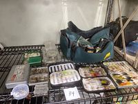 Overall lot displayed on metal shelf showing soft carrying case filled with assorted fly fishing lures and accessories including small boxes and trays.