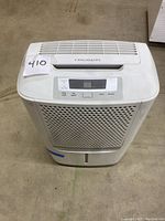 Front view of Frigidaire dehumidifier showing vented front panel and top control area.