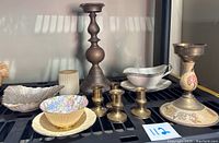 Full view of lot showing Lenox small bowl, brass candle holders, Winterling Bavaria gravy bowl with underplate, Shelley teacup with saucer, and candle.