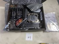 Top view of the ASUS ROG STRIX X470-F Gaming motherboard showing PCIe slots, DIMM slots, CPU socket, and heatsinks with ROG logo.