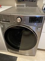 Front view of the LG front-load washing machine showing door and control panel
