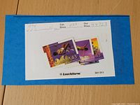 Three Canadian postage stamps from 1994 Commonwealth Games mounted on blue Leuchtturm album paper with catalog and price details written above.