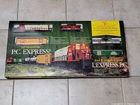 Top view of the sealed P.C. Express Limited Edition train set box showing visible train cars through plastic windows and colorful box graphics.