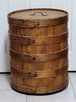 Front angle of oak decorative wine barrel showing wood, metal bands, and lid with handle.