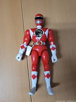 Front view of the Red Ranger figure displaying detailed chest emblem and arm and leg diamond patterns.