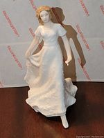 Front view of the Royal Doulton figurine showing the woman in a flowing dress.