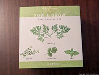 Front of the Sow & Grow Seed Starter Kit showing illustrations of parsley, cilantro, basil, and thyme herbs.