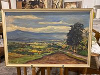 Full view of the antique landscape painting showing a rural scene with road, trees, fields, and mountains.