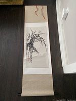 Full view of the vintage Chinese hand-painted scroll unrolled on floor showing plant motif and calligraphy.