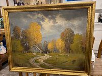 Front view of the vintage landscape painting showing autumn trees, farmhouse, winding path, sheep, and cloudy sky in gold frame.