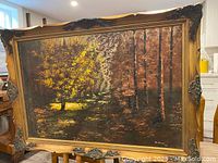 Full view of vintage framed painting showing a forest with yellow and brown foliage, signed M. Vince 1972.