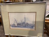 Framed watercolour painting showing Toronto waterfront skyline including CN Tower and sailboat.